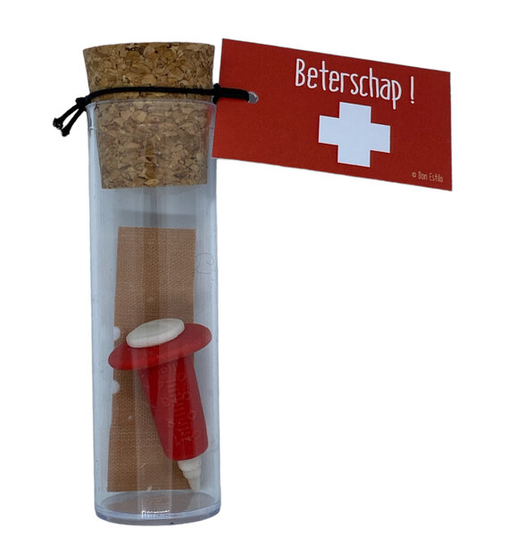 Vooraanzicht van de mini-gummetjes spuitje en pleister in het glazen flesje