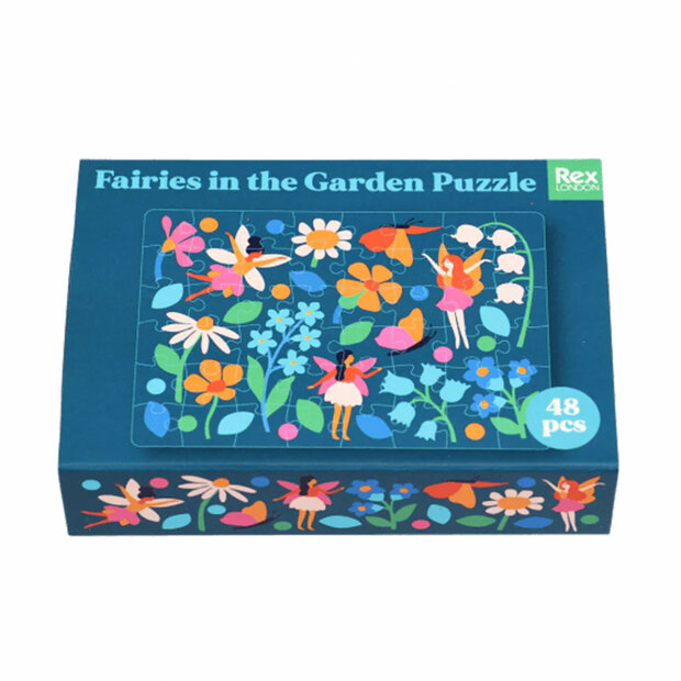 Mini puzzel met afbeelding van elfjes en bloemen in een klein doosje.